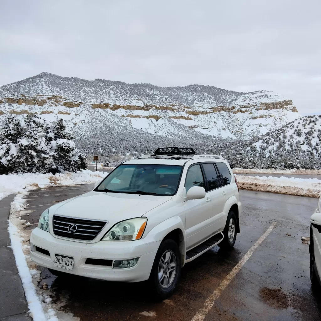 car with utah snowy  mountains in background