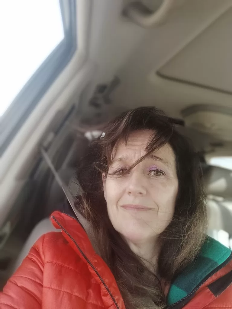 woman driving with hair flying in breeze