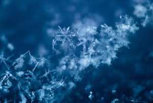 Detailed macro shot of snowflakes showcasing their intricate designs and delicate formations. death of my father