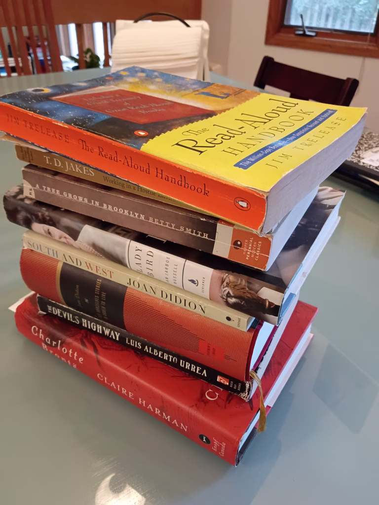 Stack of paper books I've been reading on my kitchen table, reading on paper